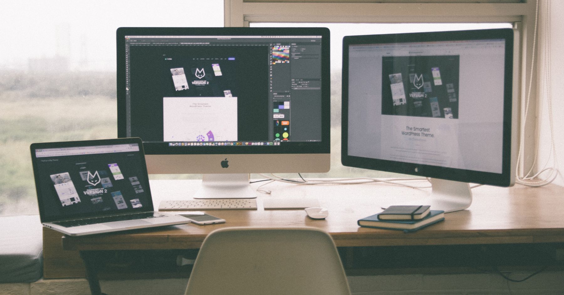 desk setup with two monitors and laptop.